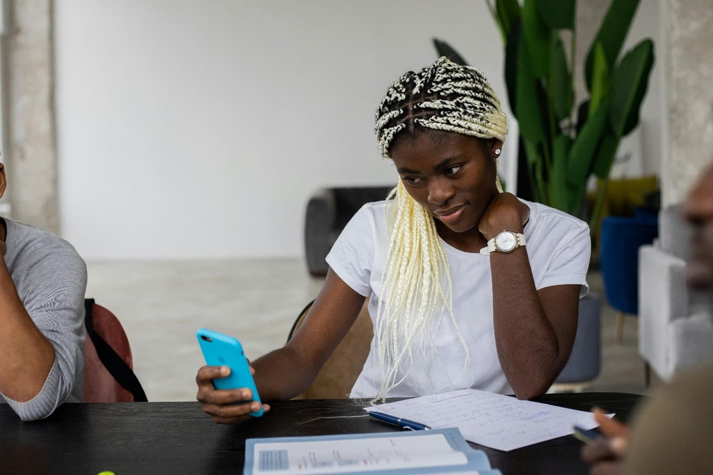 A learner checking course notes on her phone during class